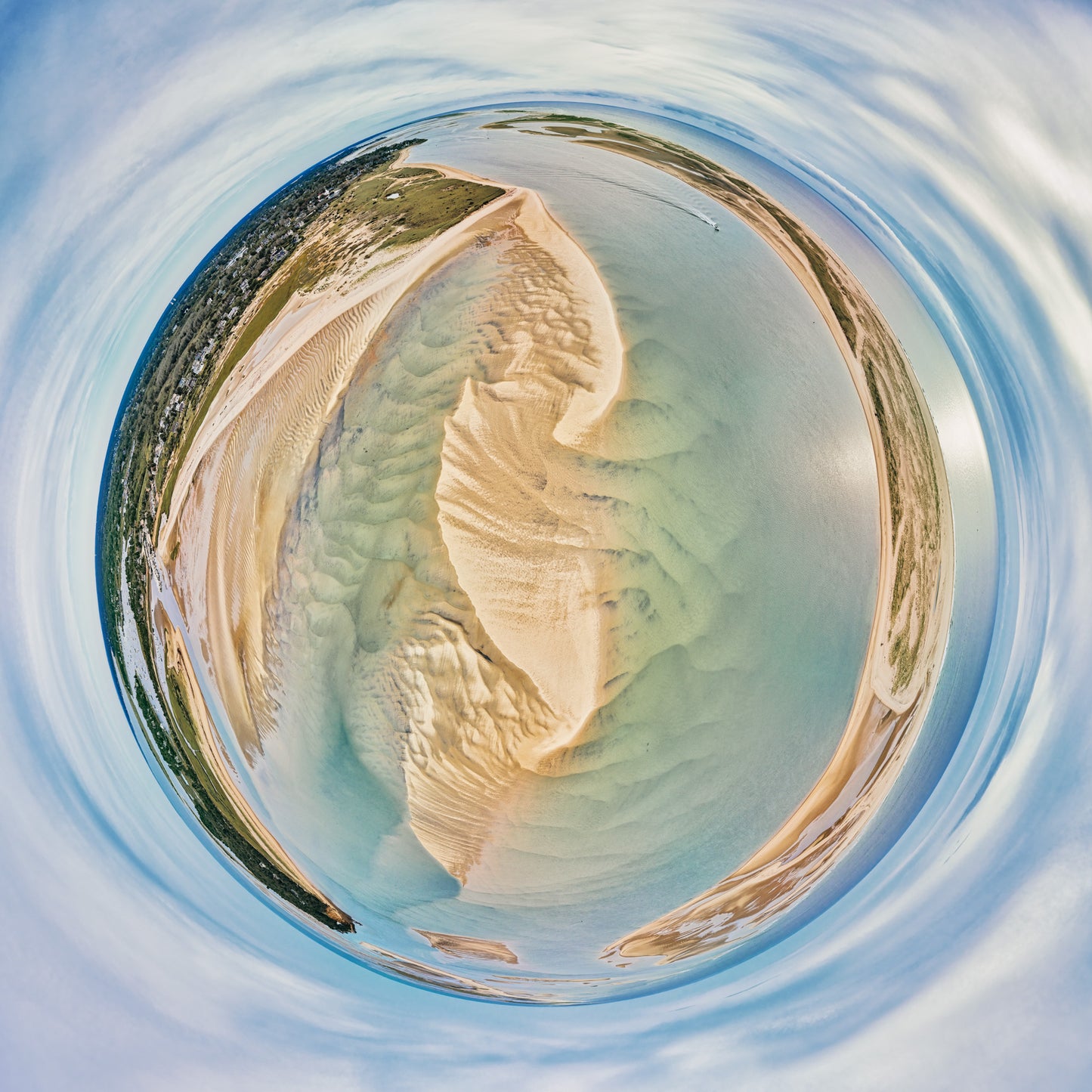 360-degree “tiny planet” image of Chatham Harbor, with sculpted sandbars and tidal flats in pale gold surrounded by turquoise-green water and a circular blue sky, forming a serene spherical coastal landscape.