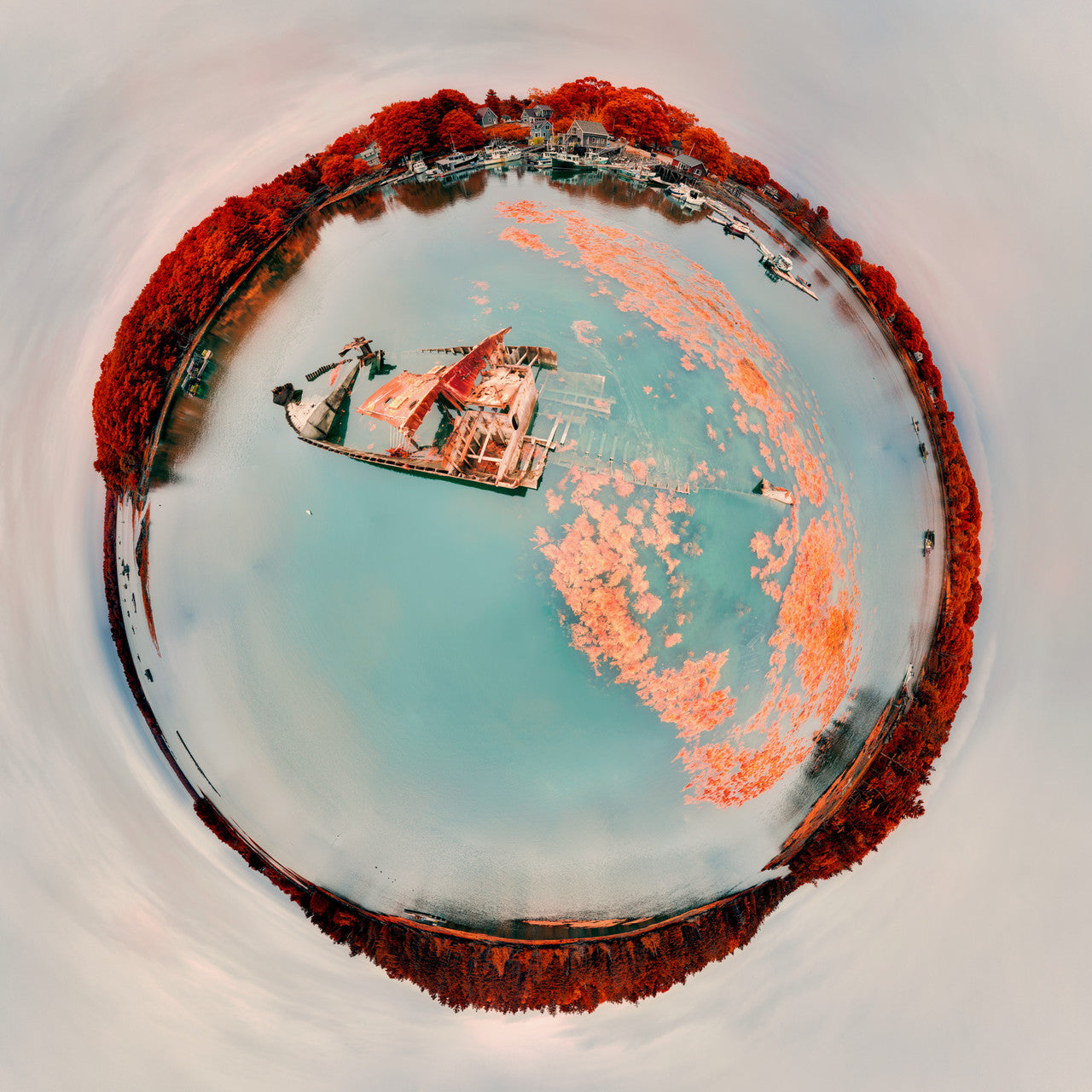 A 360-degree panoramic Spherescape depicting an infrared view of a small shipwreck in Cundy's Harbor, Harpswell, Maine, with foliage in vivid red and water in soft aqua hues, creating a surreal maritime scene