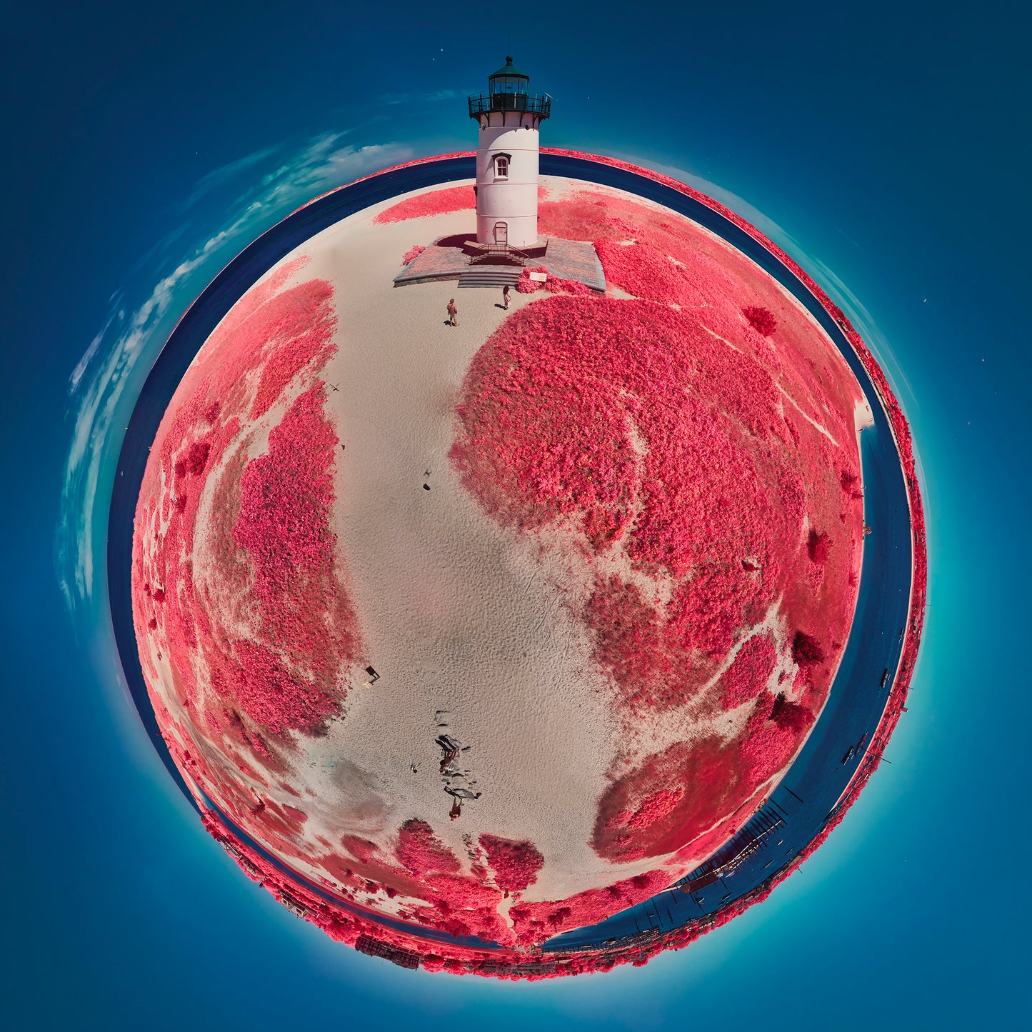 A 360-degree infrared panoramic photograph of Edgartown Harbor Light, showing a circular view of the lighthouse surrounded by crimson vegetation and sandy paths against a deep blue sky.
