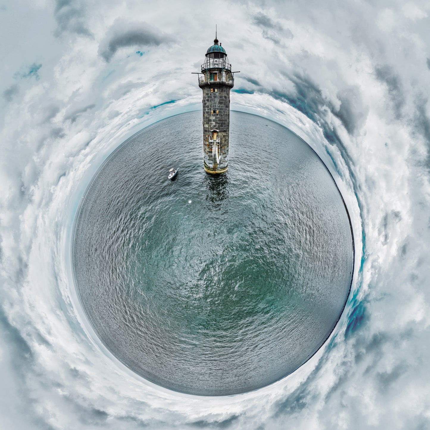 360-degree panoramic photograph of Minot's Ledge Light rising from gray-green waters, with a small boat nearby and dramatic clouds swirling overhead in a perfect circular composition.