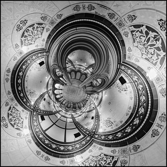 Black and white spherical panoramic photograph of Bethesda Terrace's ornate Victorian architecture, transformed into a kaleidoscopic pattern with concentric arches and elaborate floral decorations spiraling toward a central point.