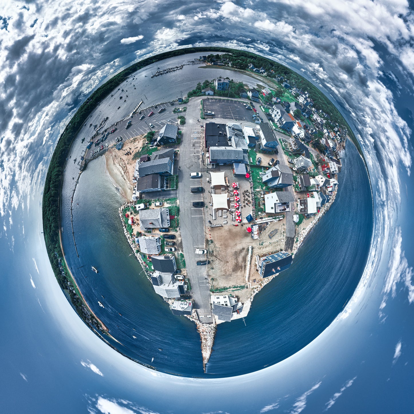 Spherical panoramic photograph of Camp Ellis, Maine, showing the jetty extending into blue waters, surrounded by coastal homes, fishing boats, and swirling clouds in a dramatic sky.