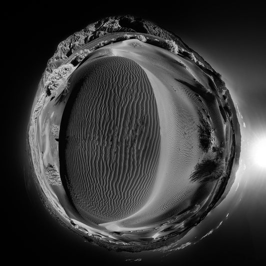 A dynamic black and white infrared panoramic spherescape of the Mesquite Flat Sand Dunes at Death Valley National Park, embodying a stark interplay of light and texture.