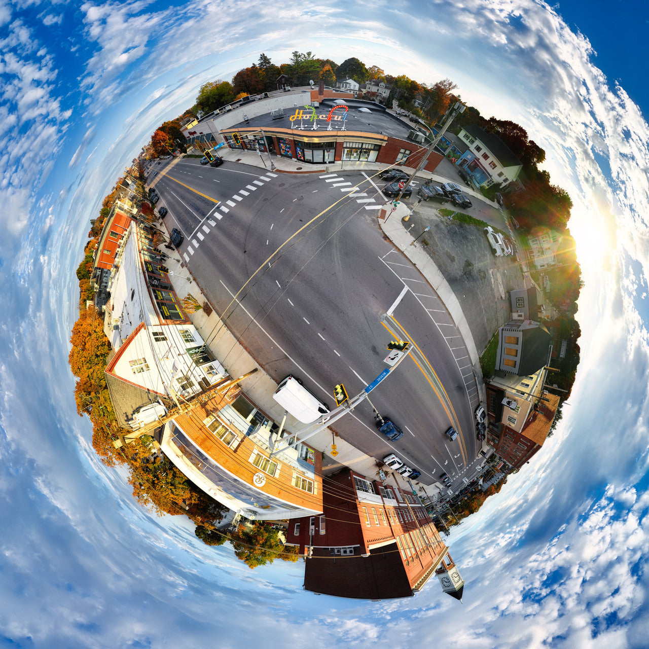 Vibrant 360-degree spherescape of Portland, Maine, featuring the "Hopeful" sign with dynamic city streets and buildings contrasting against a serene blue sky, capturing a message of optimism and community.