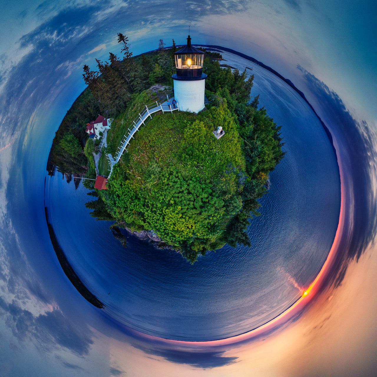 A panoramic Spherescape of Owls Head Light at sunrise, with vivid greenery, calm seas, and a vibrant sunrise enveloping the scene in a circular embrace