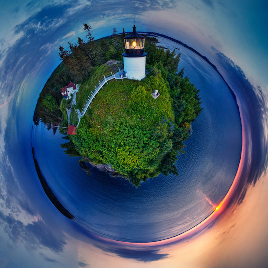 A panoramic Spherescape of Owls Head Light at sunrise, with vivid greenery, calm seas, and a vibrant sunrise enveloping the scene in a circular embrace