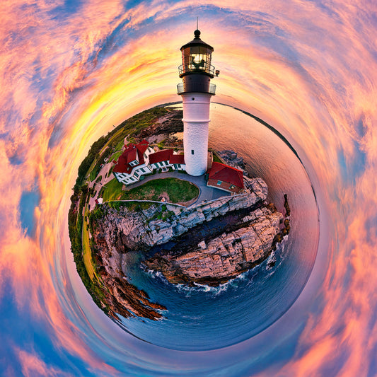 A 360-degree panoramic Spherescape at sunset featuring the historic Portland Headlight in Cape Elizabeth, Maine, enveloped by a vibrant palette of sunset colors and set against the calm expanse of the sea.